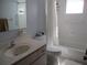 Bathroom featuring a tub with shower, a cream-colored single sink vanity, and a toilet at 14272 Sw 112Th Cir, Dunnellon, FL 34432