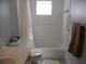 Bathroom features a shower with curtain, a single sink vanity, and a toilet at 14272 Sw 112Th Cir, Dunnellon, FL 34432