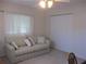 Bedroom with a sofa, a window with curtains, and a closet at 14272 Sw 112Th Cir, Dunnellon, FL 34432