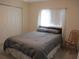 Cozy bedroom featuring a large bed with a gray comforter and a double-door closet at 14272 Sw 112Th Cir, Dunnellon, FL 34432