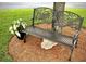 Metal butterfly bench in garden surrounded by mulch and lawn at 14272 Sw 112Th Cir, Dunnellon, FL 34432