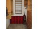 The walk in closet features storage shelves, a dresser, and a red floral bench at 14272 Sw 112Th Cir, Dunnellon, FL 34432
