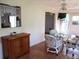 Dining area featuring a glass table, white wicker chairs, and hardwood floors at 14272 Sw 112Th Cir, Dunnellon, FL 34432