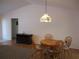 Charming dining room featuring a decorative light fixture and hardwood floors at 14272 Sw 112Th Cir, Dunnellon, FL 34432