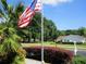 Charming home featuring a well-maintained yard and vibrant American flag, perfect for patriotic homeowners at 14272 Sw 112Th Cir, Dunnellon, FL 34432