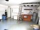 Clean and organized garage featuring storage cabinets, workbench, and water heater at 14272 Sw 112Th Cir, Dunnellon, FL 34432