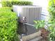 Outside HVAC unit surrounded by green bushes at 14272 Sw 112Th Cir, Dunnellon, FL 34432