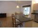 Open-concept kitchen featuring granite countertops, stainless steel appliances, and barstool seating at 14272 Sw 112Th Cir, Dunnellon, FL 34432