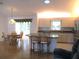 Open-concept kitchen featuring granite countertops, stainless steel appliances, and seating at the island at 14272 Sw 112Th Cir, Dunnellon, FL 34432