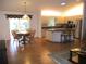 Open-concept kitchen with granite countertops, stainless steel appliances, and warm natural lighting at 14272 Sw 112Th Cir, Dunnellon, FL 34432