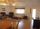 Inviting living room featuring hardwood floors, comfortable seating, and a well-lit ambiance at 14272 Sw 112Th Cir, Dunnellon, FL 34432