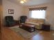 Comfortable living room featuring hardwood floors, neutral-toned furniture, and ample natural light at 14272 Sw 112Th Cir, Dunnellon, FL 34432