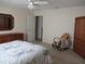 Bright main bedroom features neutral walls, ceiling fan and an ensuite entrance to a bathroom at 14272 Sw 112Th Cir, Dunnellon, FL 34432