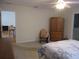 A neutral main bedroom features a ceiling fan, and an ensuite entrance to a bathroom and possible office at 14272 Sw 112Th Cir, Dunnellon, FL 34432