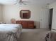 Bright main bedroom features neutral walls, ceiling fan and an ensuite entrance to a bathroom and walk in closet at 14272 Sw 112Th Cir, Dunnellon, FL 34432