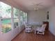 Bright sunroom with large windows offering views of the landscaped backyard and filled with light at 14272 Sw 112Th Cir, Dunnellon, FL 34432