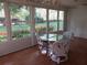 Bright sunroom with large windows offering views of the beautifully landscaped backyard at 14272 Sw 112Th Cir, Dunnellon, FL 34432