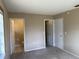Neutral-toned bedroom featuring two doors and carpeted floors at 15036 Sw 35Th Cir, Ocala, FL 34473
