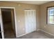 Comfortable bedroom with closet, window, and carpeted floors at 15036 Sw 35Th Cir, Ocala, FL 34473