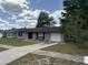 Charming single-story home featuring a well-kept lawn, driveway, and classic design elements at 15036 Sw 35Th Cir, Ocala, FL 34473