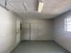 Spacious garage with neutral walls, window, and doors at 15036 Sw 35Th Cir, Ocala, FL 34473