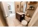 Bathroom with dark wood vanity, decorative mirrors, and doorway to sitting room at 1509 Ne 50Th Ter, Ocala, FL 34470