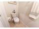Powder room features an elongated toilet, towel, and stylish decor at 1509 Ne 50Th Ter, Ocala, FL 34470