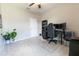 Spacious bedroom features plush carpet, ceiling fan and is styled as modern office at 1509 Ne 50Th Ter, Ocala, FL 34470