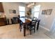 Dining area with chandelier, art work, and wine cooler next to dark wood dining table at 1509 Ne 50Th Ter, Ocala, FL 34470