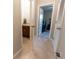 Hallway featuring a bathroom and bedroom that features a ceiling fan at 1509 Ne 50Th Ter, Ocala, FL 34470
