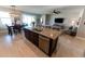 Kitchen island with stainless steel dishwasher, granite countertops, and double sink with view to living area at 1509 Ne 50Th Ter, Ocala, FL 34470