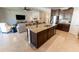 Kitchen with granite countertops, island seating, stainless steel appliances, and views to living area at 1509 Ne 50Th Ter, Ocala, FL 34470