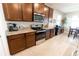 Gourmet kitchen features stainless steel appliances, granite countertops, and ample cabinet space for storage at 1509 Ne 50Th Ter, Ocala, FL 34470