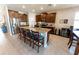 Spacious kitchen featuring an oversized island with seating, dark wood cabinets, and stainless steel appliances at 1509 Ne 50Th Ter, Ocala, FL 34470