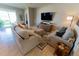 Bright living room features comfortable seating, stylish decor, and abundant natural light through a large window at 1509 Ne 50Th Ter, Ocala, FL 34470