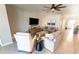 Cozy living room with neutral tones, recessed lighting, ceiling fan, and large TV for ultimate relaxation at 1509 Ne 50Th Ter, Ocala, FL 34470