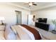 Open main bedroom leading to other rooms, featuring a ceiling fan and television set at 1509 Ne 50Th Ter, Ocala, FL 34470