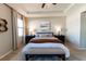 Spacious main bedroom featuring a ceiling fan, tray ceiling, and neutral color scheme at 1509 Ne 50Th Ter, Ocala, FL 34470