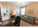 Inviting home office featuring neutral tones, ample lighting, and a comfortable sofa at 1509 Ne 50Th Ter, Ocala, FL 34470