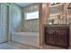Clean bathroom featuring a bathtub and vanity with stone countertop and dark cabinetry at 1551 Sw Willow Road Ext, Dunnellon, FL 34431