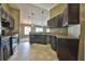 View of the kitchen featuring dark cabinetry, light countertops and ceramic tile flooring at 1551 Sw Willow Road Ext, Dunnellon, FL 34431
