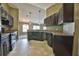 View of the kitchen featuring dark cabinetry, light countertops and ceramic tile flooring at 1551 Sw Willow Road Ext, Dunnellon, FL 34431