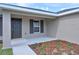 Inviting front entrance with a covered porch and decorative mulch, adding to the home's charm at 16219 Sw 48Th Cir, Ocala, FL 34473