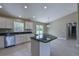 Kitchen with stainless appliances, white cabinets, and a kitchen island with dark granite at 16219 Sw 48Th Cir, Ocala, FL 34473