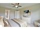 Bedroom with tray ceiling, ceiling fan, neutral walls, carpeted floors, and view to bathroom at 16219 Sw 48Th Cir, Ocala, FL 34473