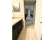 Bathroom features a dark vanity and a view into the hall at 20386 Sw 95Th St, Dunnellon, FL 34431