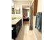 Bathroom vanity with granite countertop and open doorway to bedroom at 20386 Sw 95Th St, Dunnellon, FL 34431