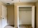 Cozy bedroom features neutral carpet, closet with shelving, and neutral walls at 20386 Sw 95Th St, Dunnellon, FL 34431