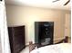 Bedroom with wooden dresser and gun safe at 20386 Sw 95Th St, Dunnellon, FL 34431