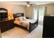 Traditional-style bedroom features a large bed, dresser, and neutral carpet at 20386 Sw 95Th St, Dunnellon, FL 34431
